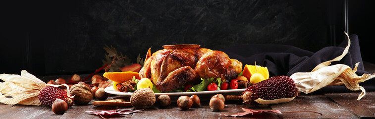 Baked turkey or chicken. The Christmas table is served with a turkey, decorated with fruits, salad and nuts. Fried chicken, table. Christmas dinner