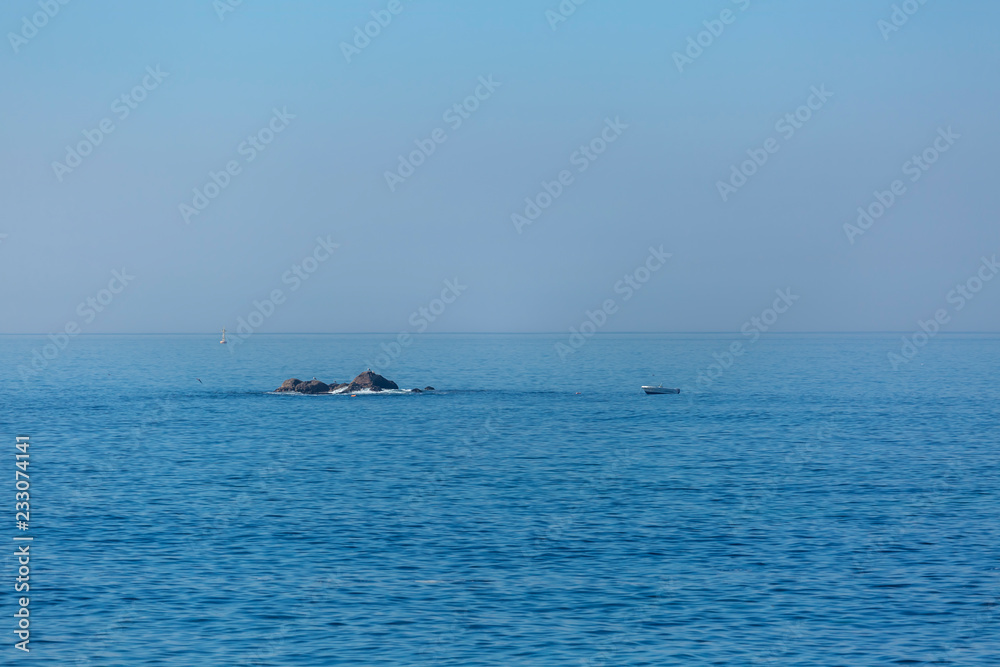View of the atlantic ocean with sea, boat and rocks on the coast of Leca da Palmeira