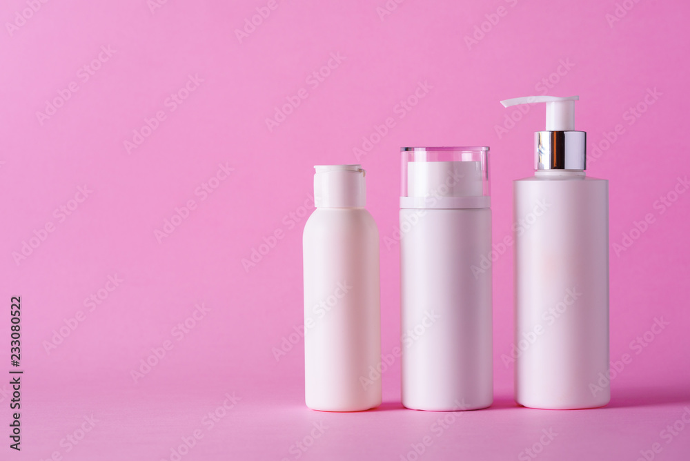 White cosmetic tubes on pink background with copy space. Skin care, body treatment, beauty concept White cosmetic tubes on pink background with copy space. Skin care, body treatment, beauty concept
