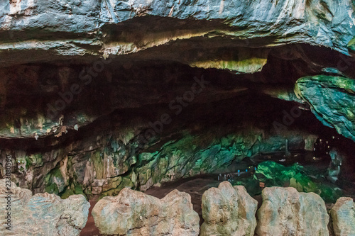 Fullshot of people waiting in the entrance of one of the biggest caves in the world photo