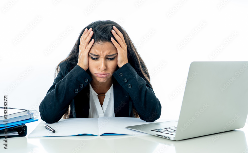 Desperate beautiful young businesswoman working on her laptop going crazy with loads of work Desperate beautiful young businesswoman working on her laptop going crazy with loads of work