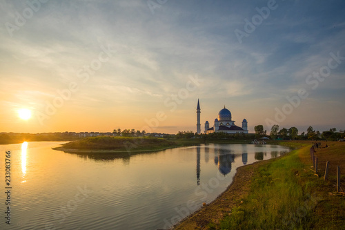 sunrise scenery at Public Mosque Penang with reflection. soft focus,blur due to long exposure. visible noise due to high ISO.