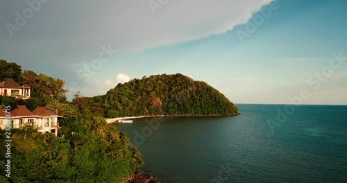 drone shot revealing hidden private beach during golden hour sunset in thailand photo