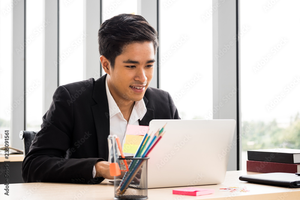 Happy Businessman is working at the office. Happy Businessman is working at the office.