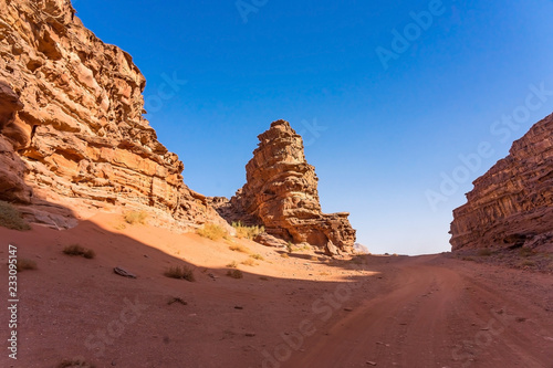 Red mountains of Wadi Rum desert in Jordan. Wadi Rum also known as The Valley of the Moon is a valley cut into the sandstone and granite rock in southern Jordan to the east of Aqaba