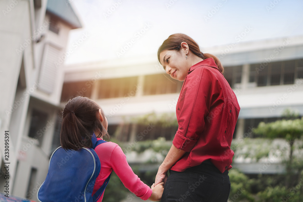 Back to school concept, Mother or parent holding hand  daughter or pupil with backpack to school, Selective focus.