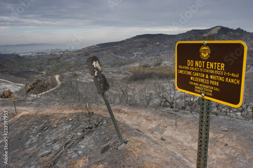 Scorched landscape and sign after California wildfires