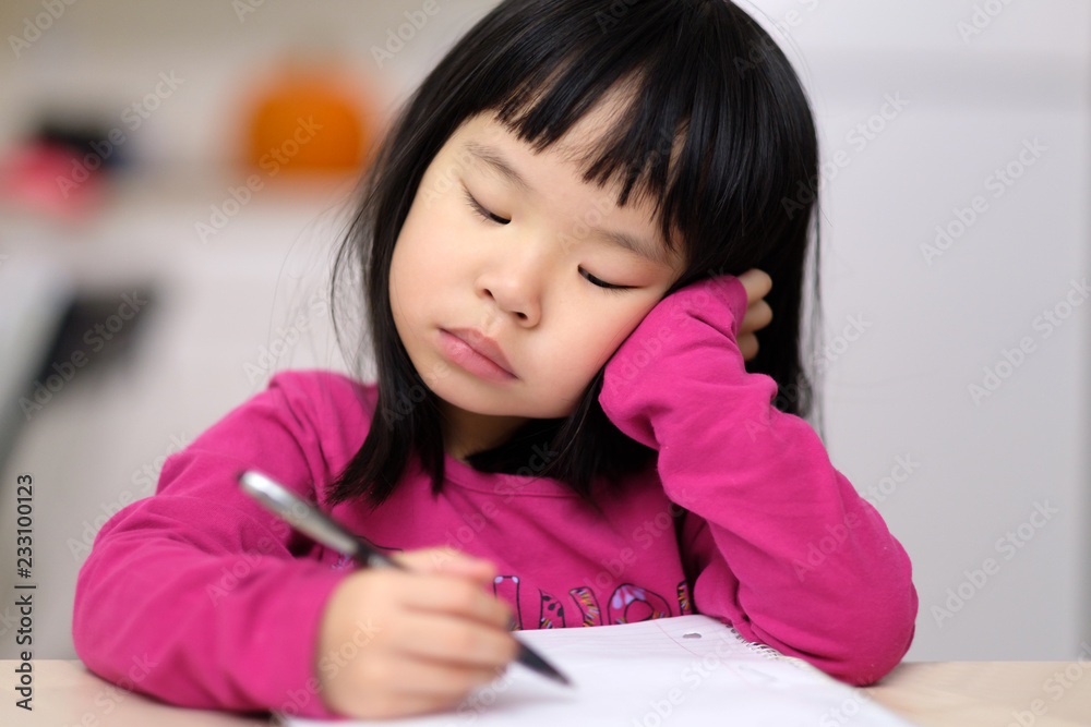 Early childhood education conceptual with a young little Asian girl learning to write Early childhood education conceptual with a young little Asian girl learning to write