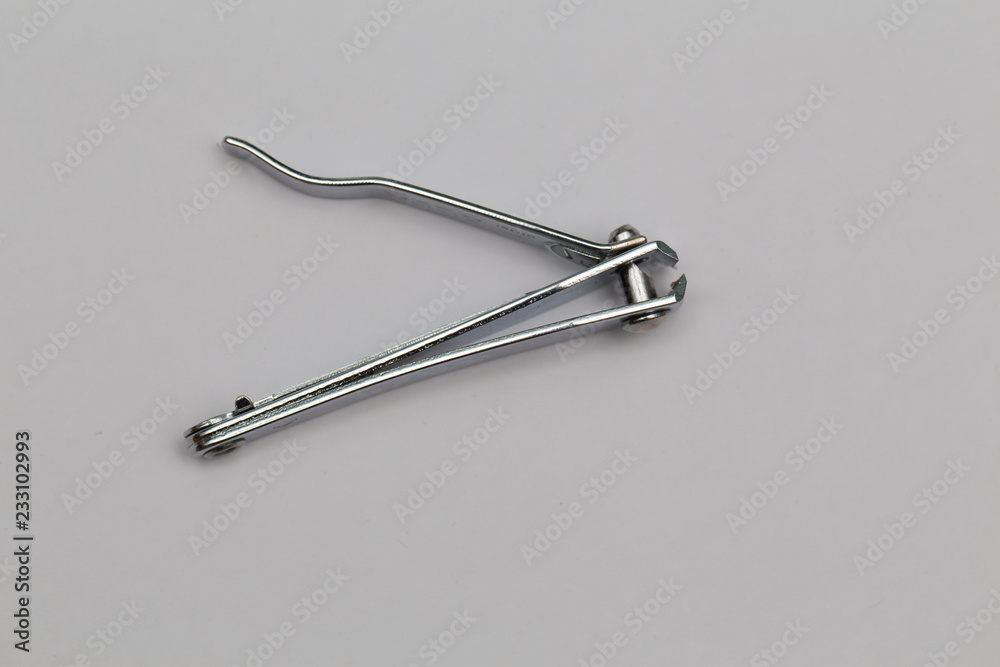 used metallic nail cutters against white background used metallic nail cutters against white background