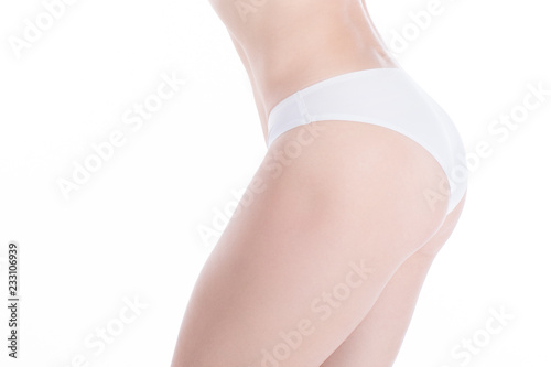 Female cropped well groomed body back and butt in white underwear, isolated on white.