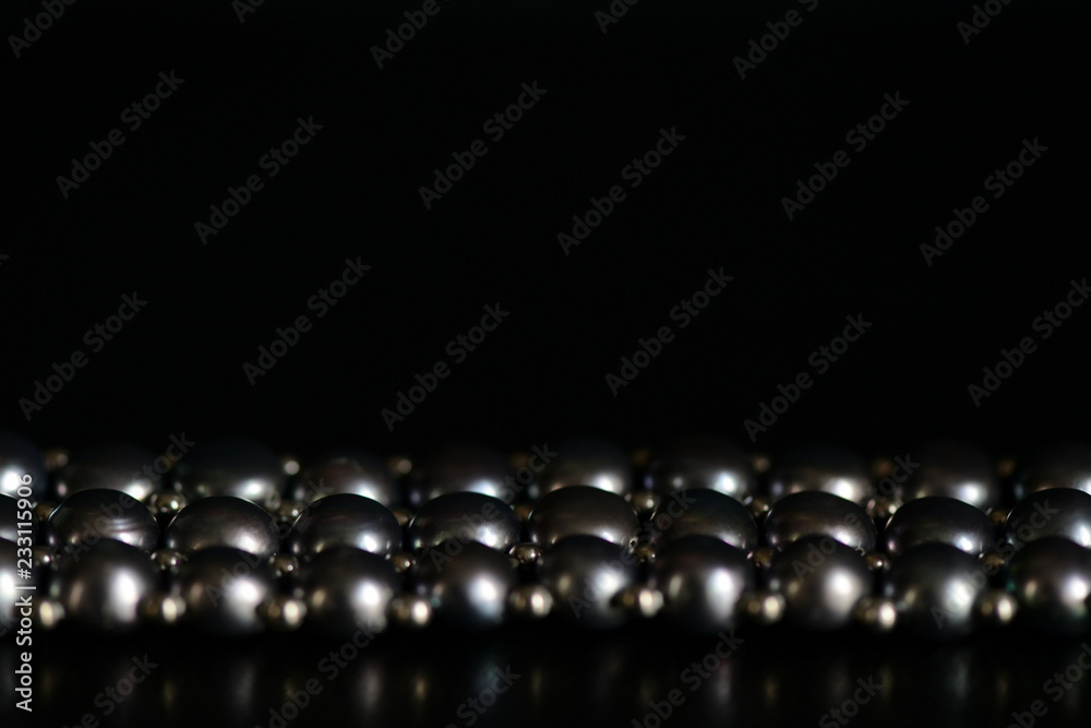 Black pearl necklace on a dark background close up Black pearl necklace on a dark background close up