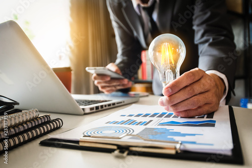 business hand showing creative business strategy with light bulb as concept