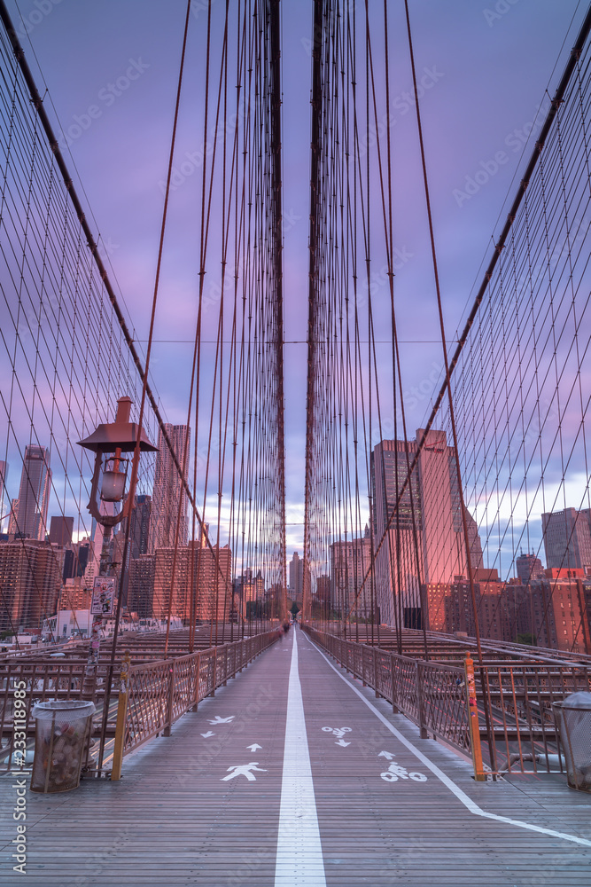 Fototapeta premium Sunrise Brooklyn bridge view from walkway, long exposure