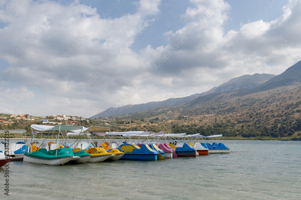 colorful boats and catamarans on the lake in the kournas mountains in Crete, Greece