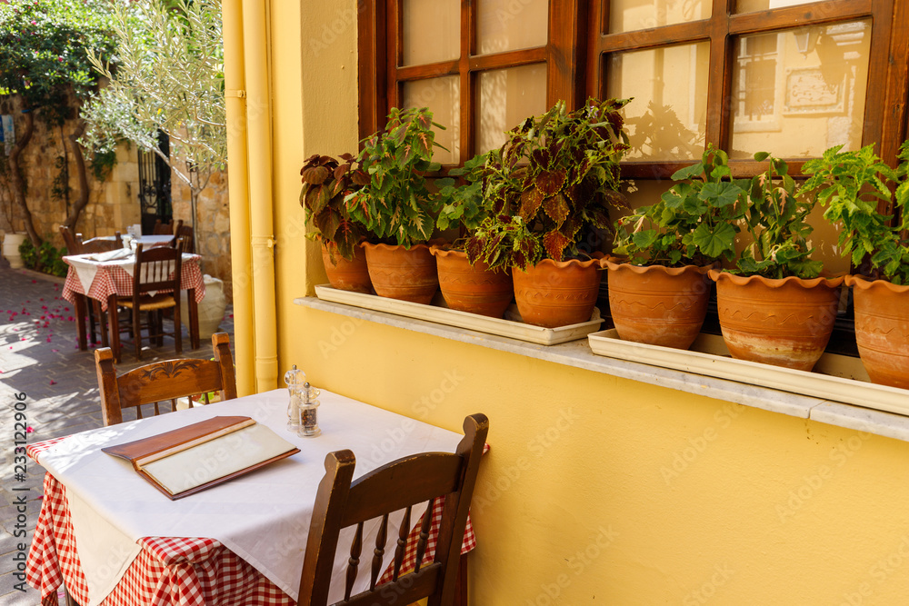 national flavor, ancient Greek streets on the island of Crete. Old houses, doors, Windows, potted plants and small outdoor cafes. national flavor, ancient Greek streets on the island of Crete. Old houses, doors, Windows, potted plants and small outdoor cafes.