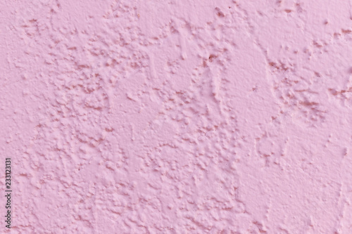 the background image of a textured surface of pink plaster