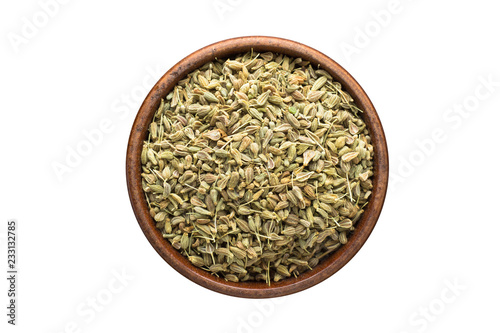 anise seeds spice in wooden bowl, isolated on white background. Seasoning top view