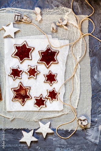 Star shaped almond biscuits filled with redcurrant jelly photo