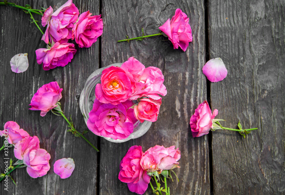 Pink rose bouquet on wooden rustic background