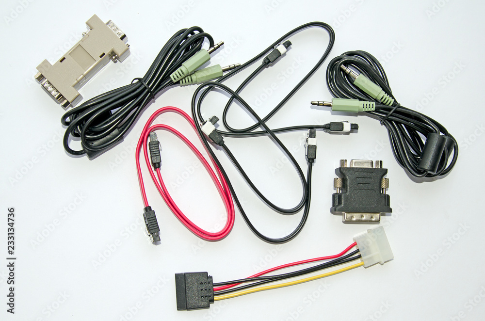 Various cables and adapters for the personal computer. On a gray background Various cables and adapters for the personal computer. On a gray background