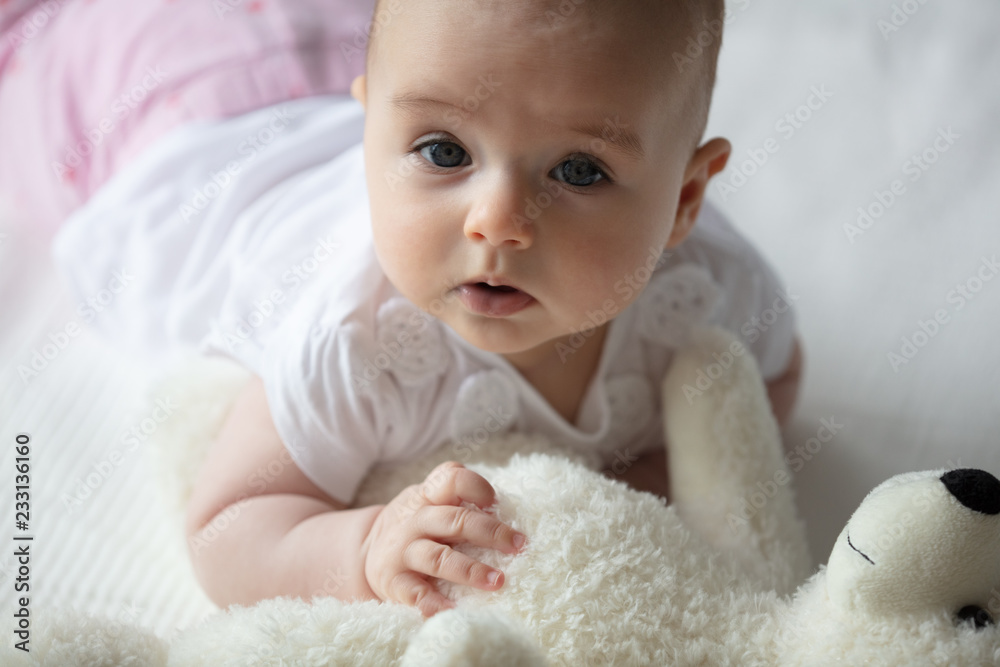 Crawling baby playing with a teddy bear Crawling baby playing with a teddy bear
