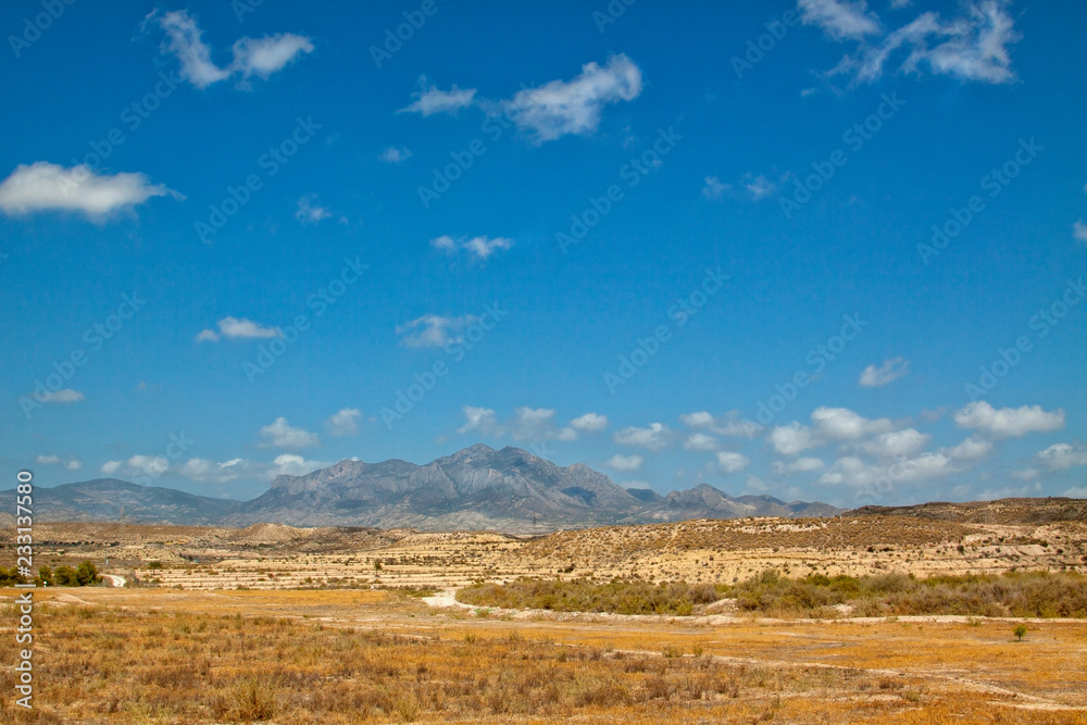 Semi-desert landscape with hills and sparingly vegetation in the vicinity of Muchamiel, Spain. Semi-desert landscape with hills and sparingly vegetation in the vicinity of Muchamiel, Spain.