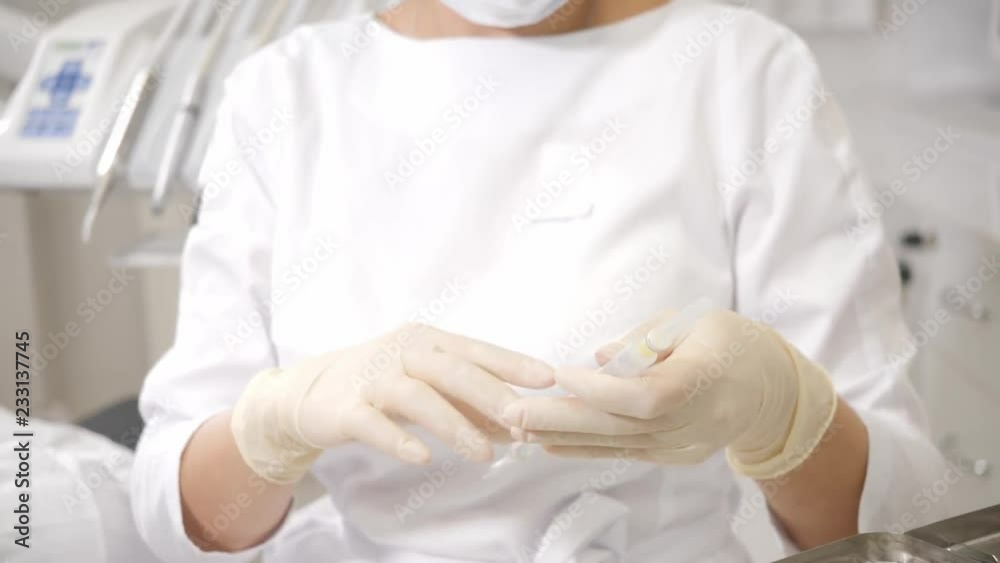 The dentist puts a shot of freezing novocaine in the jaw. Young African