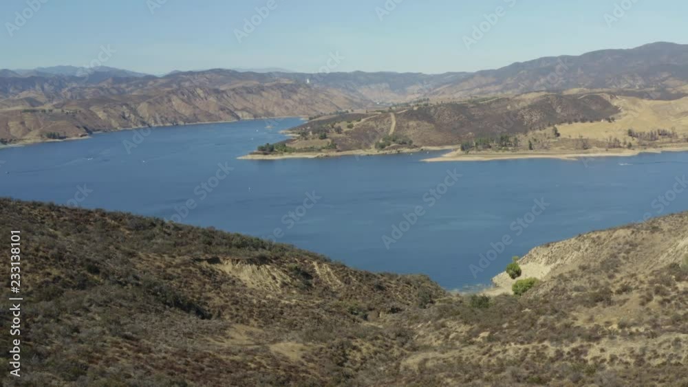 A blue lake in between hills with power boats and kayaks A blue lake in between hills with power boats and kayaks