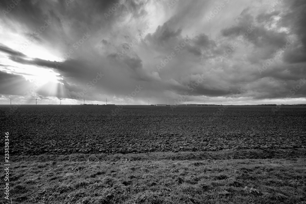 Flat Dutch polder landscape in black and white with rolling thunder clouds  and agricultural land. Stock Photo | Adobe Stock