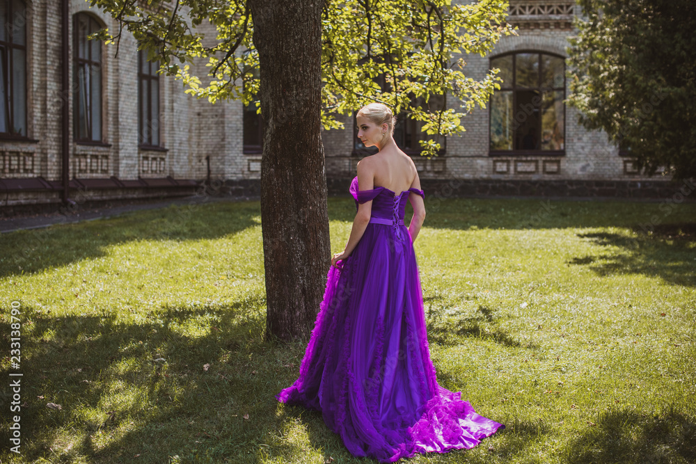Vintage clothes concept, girl in evening purple dress in garden