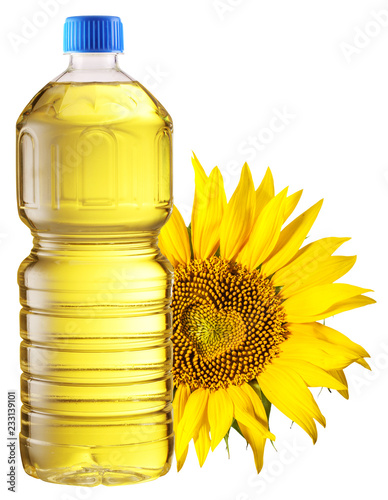Bottle of sunflower oil and sunflower at the background. File contains clipping path.