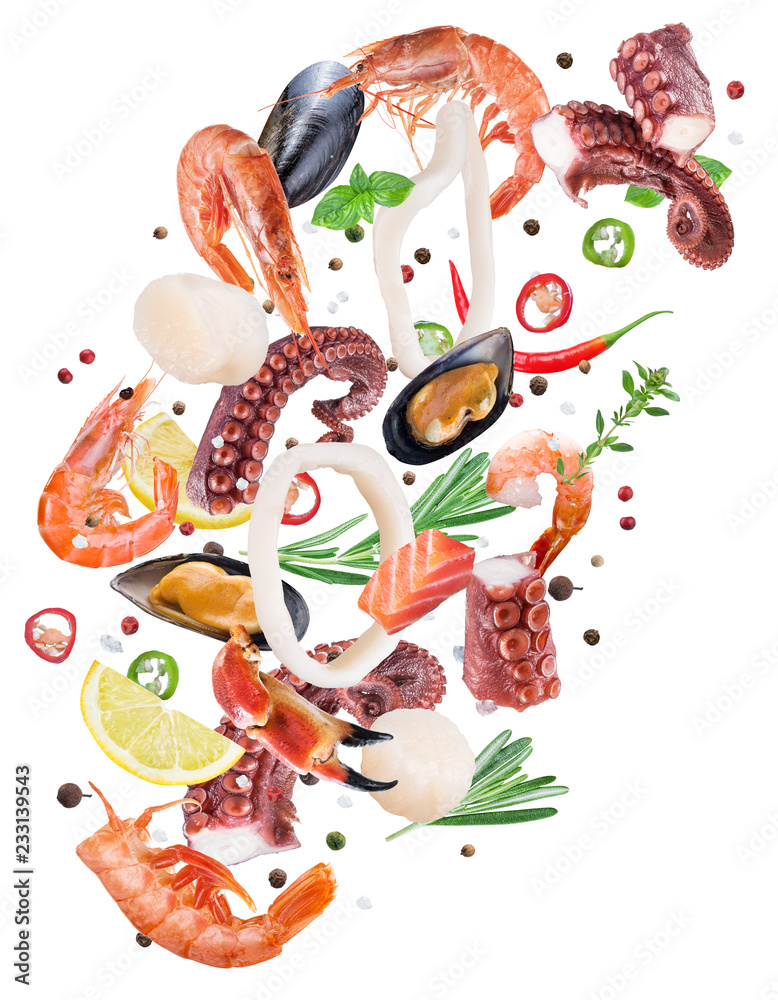 Flying seafood pieces and spices on white background. File contains clipping path.