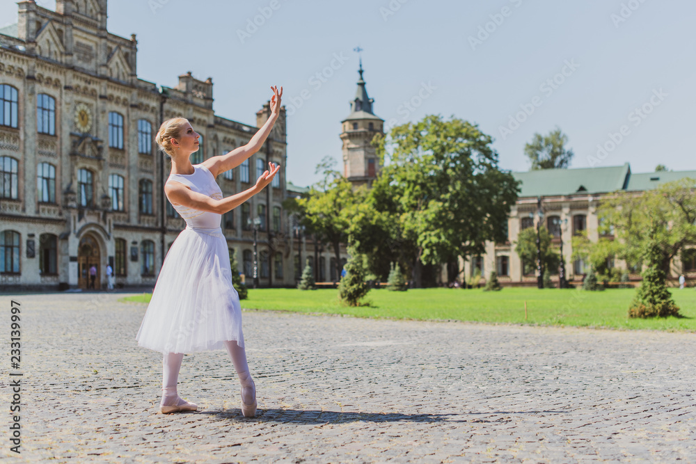 Fototapeta premium Ballet dancer at city streets, concept of elegant ballerina, inspired girl outdoor