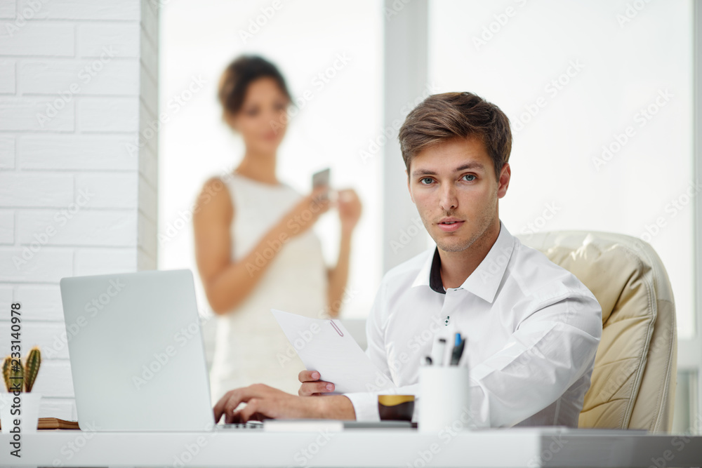 Caucasion man and woman working together in a modern office Caucasion man and woman working together in a modern office