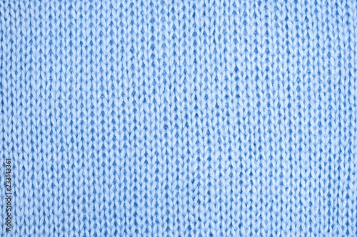 Blue knitted background. Sweater texture. Flat lay, top view, copy space 