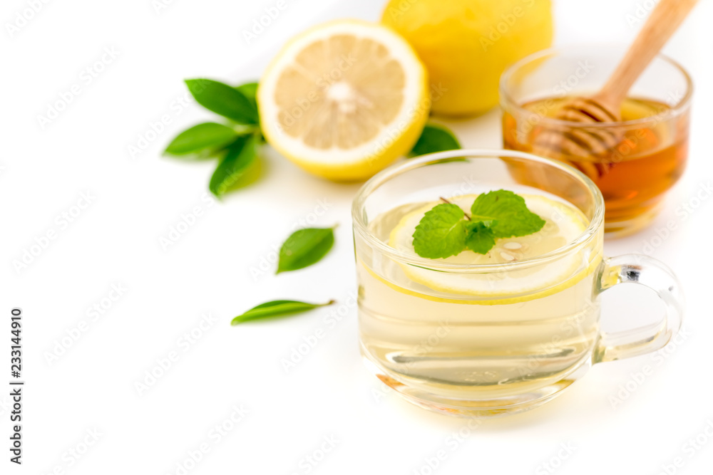 Healthy lemon tea juice in a glass with mint leaf on a white background. Healthy lemon tea juice in a glass with mint leaf on a white background.