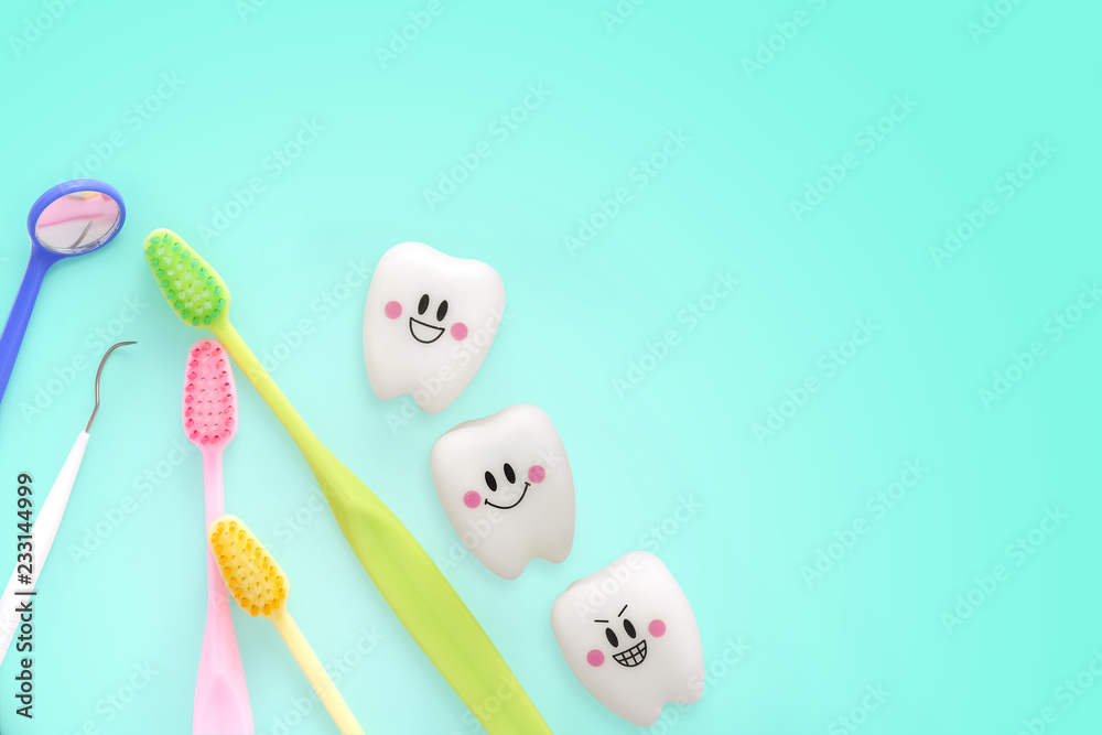 Teeth toys smile emotion with dental mirror ,dental plaque cleaning tool and tooth brush on green background, with Clipping path and copy space for your text