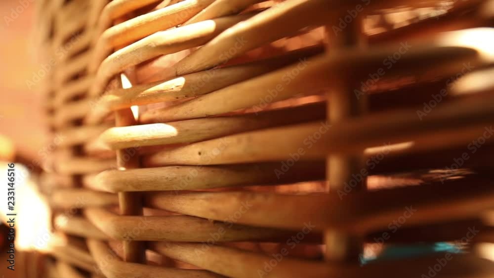 close-up macro shooting of details of a brown wicker straw handmade basket with a soft sunlight on background sunny summer day exterior detail handicraft skills courses concept natural material