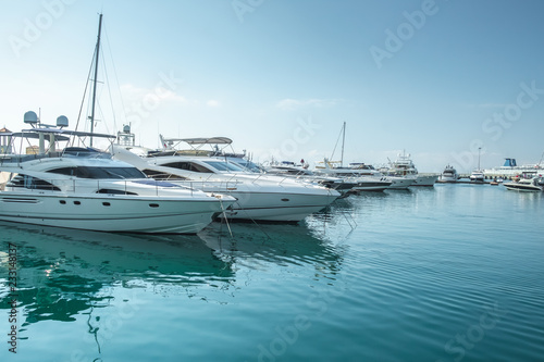 small boats and yachts are in the berth of the seaport of Sochi on the Black sea bright sunny summer day
