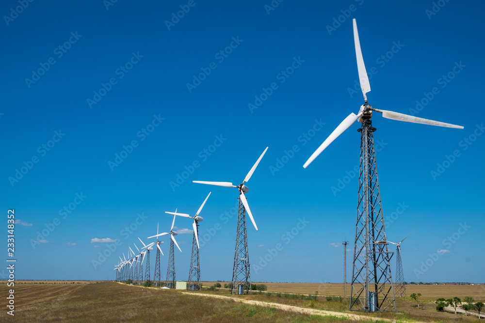 many of the old windmills standing in the fields of the Crimea in the summer day many of the old windmills standing in the fields of the Crimea in the summer day