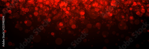 Red abstract blurred banner with bokeh effect.