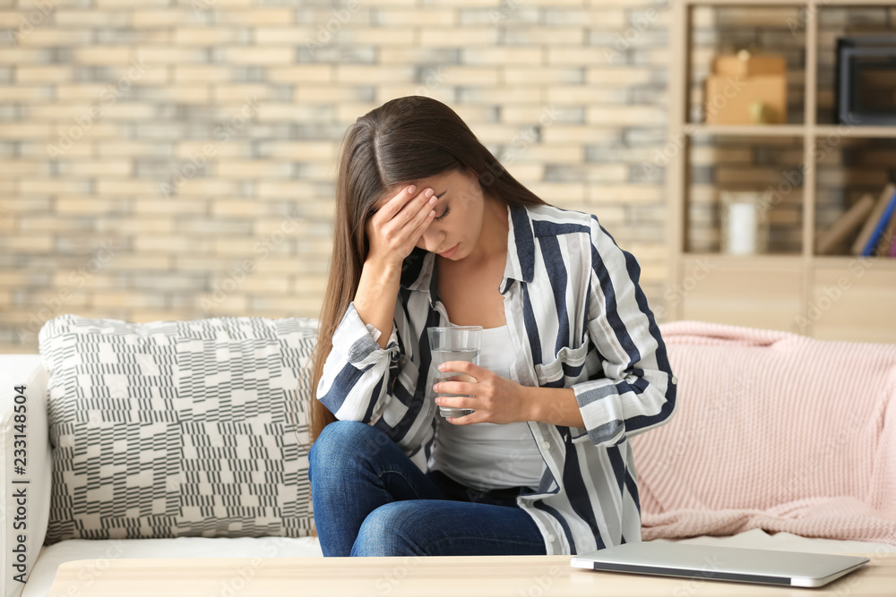 Obraz premium Woman suffering from headache at home