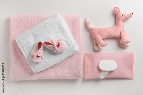Soft towels, toy and baby shoes on white background © Pixel-Shot