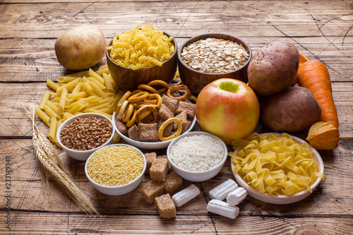 Foods high in carbohydrate on rustic wooden background. photo