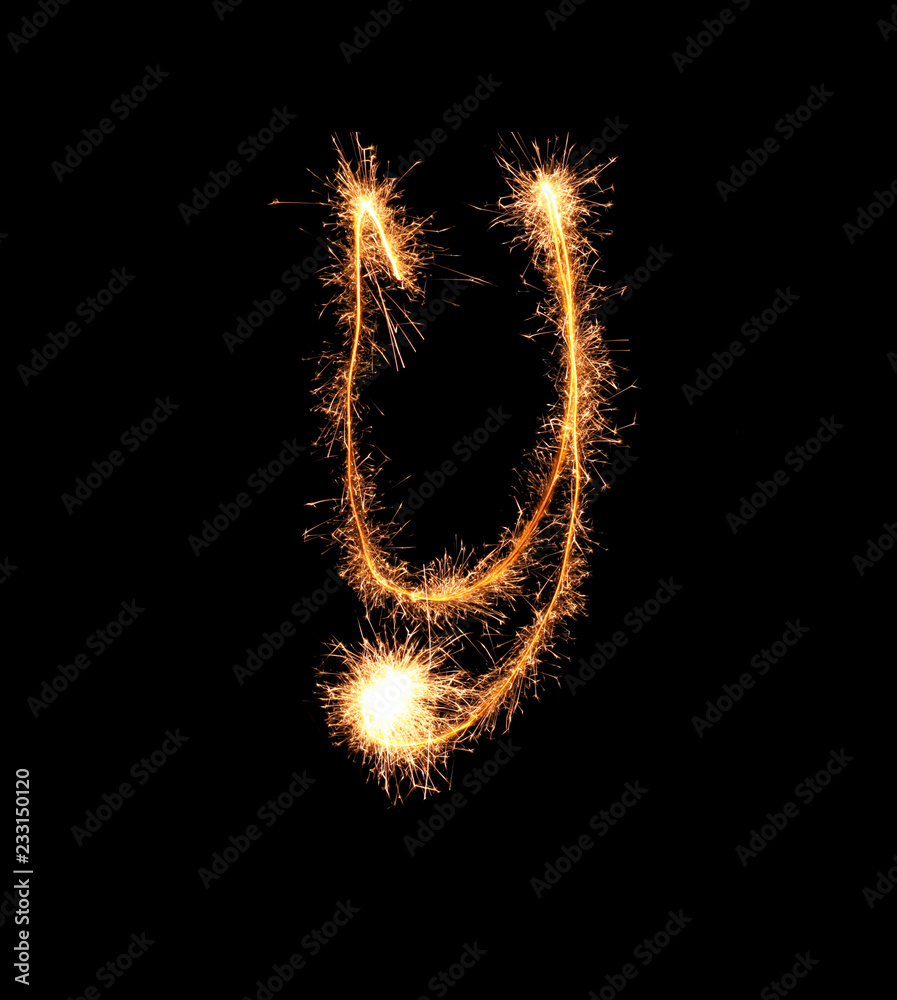 Sparklers forming letter Y on dark background