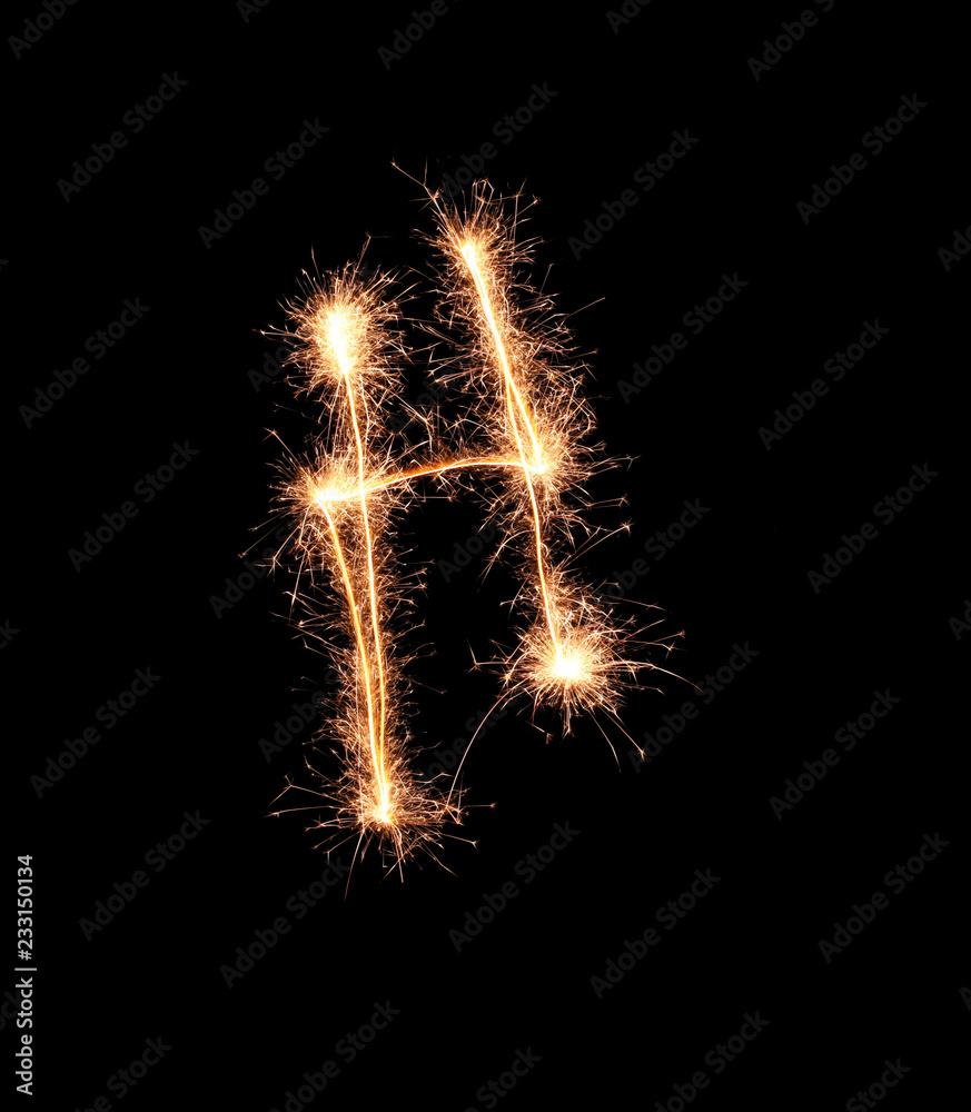 Sparklers forming letter H on dark background