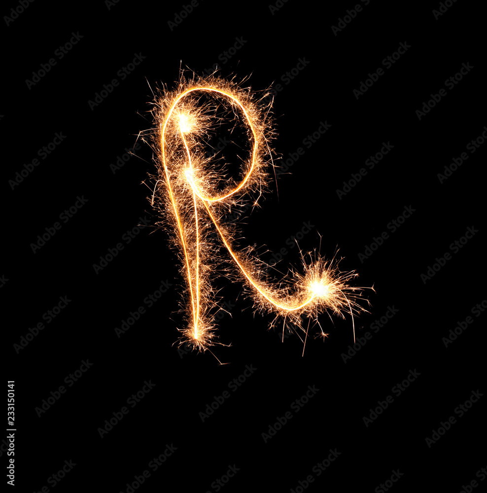 Sparklers forming letter R on dark background