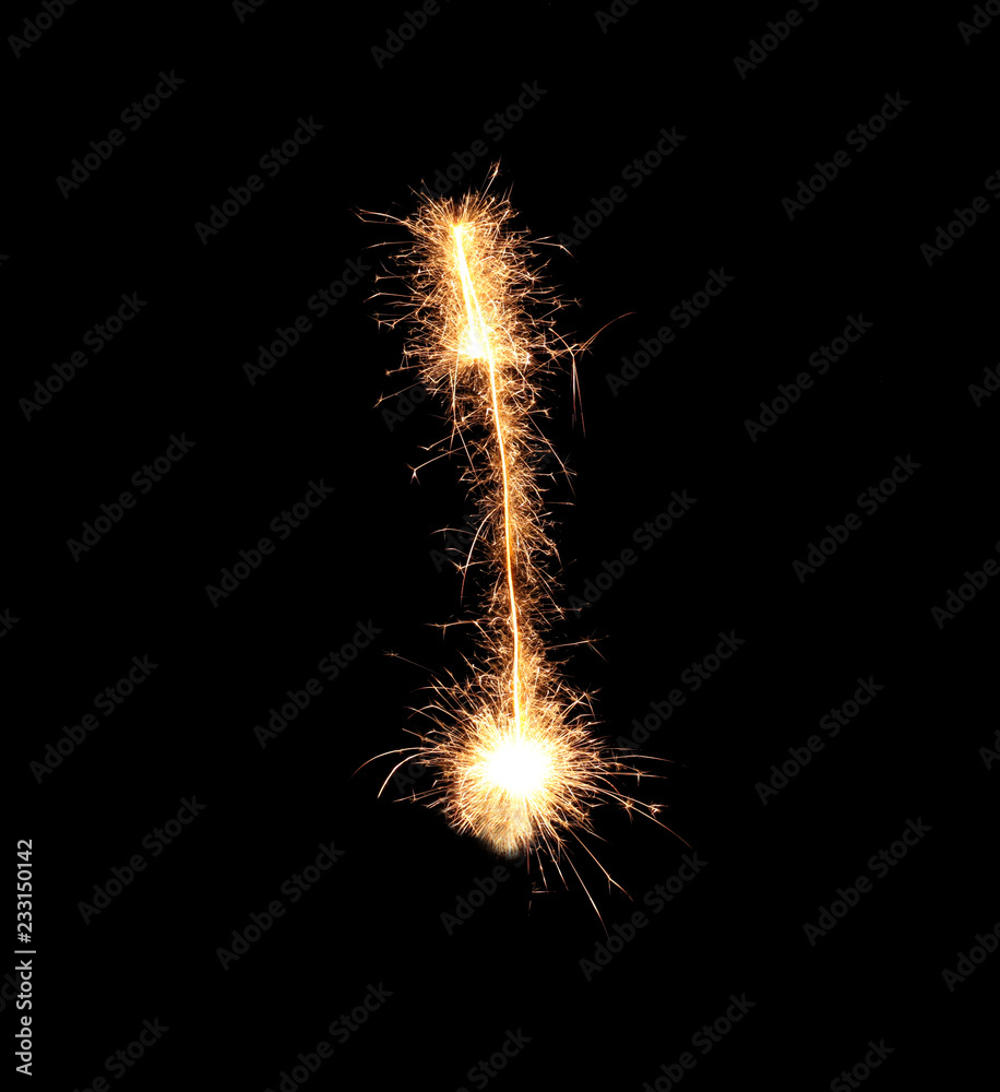 Sparklers forming letter I on dark background