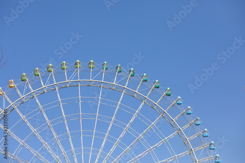 Ferris wheel in the blue sky background