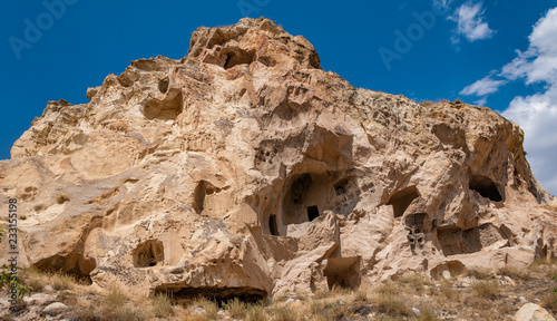 View from the structure of Cappadocia. Impressive fairy chimneys of sandstone in the canyon near Cavusin village, Cappadocia, Nevsehir Province in the Central Anatolia Region of Turkey. Overcast sky